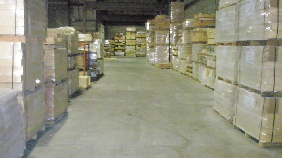 FBE Inventory Brick A warehouse stocked with stacks of fire brick, packaged on wooden pallets.