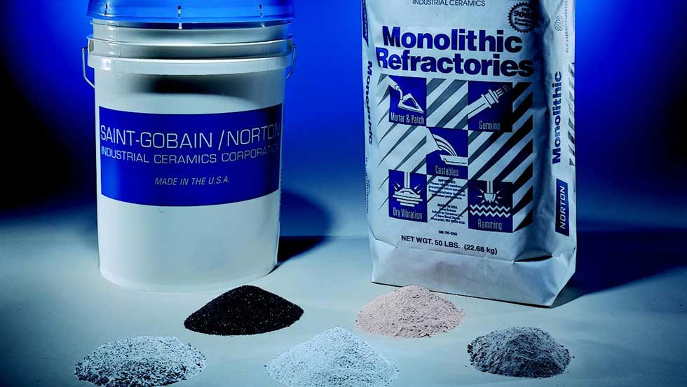 St Gobain DV Pic Photo shows a large bucket and bag of dry vibration cements, with small piles of each powdered product in front of the containers.