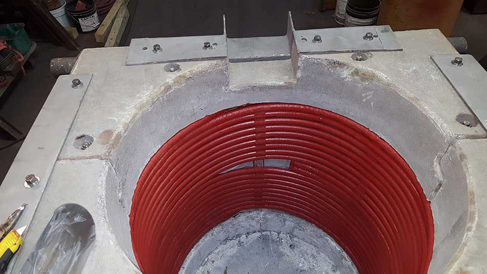 Coil 4 The interior of an induction furnace, showing the installed induction coil wrapped around the inside.