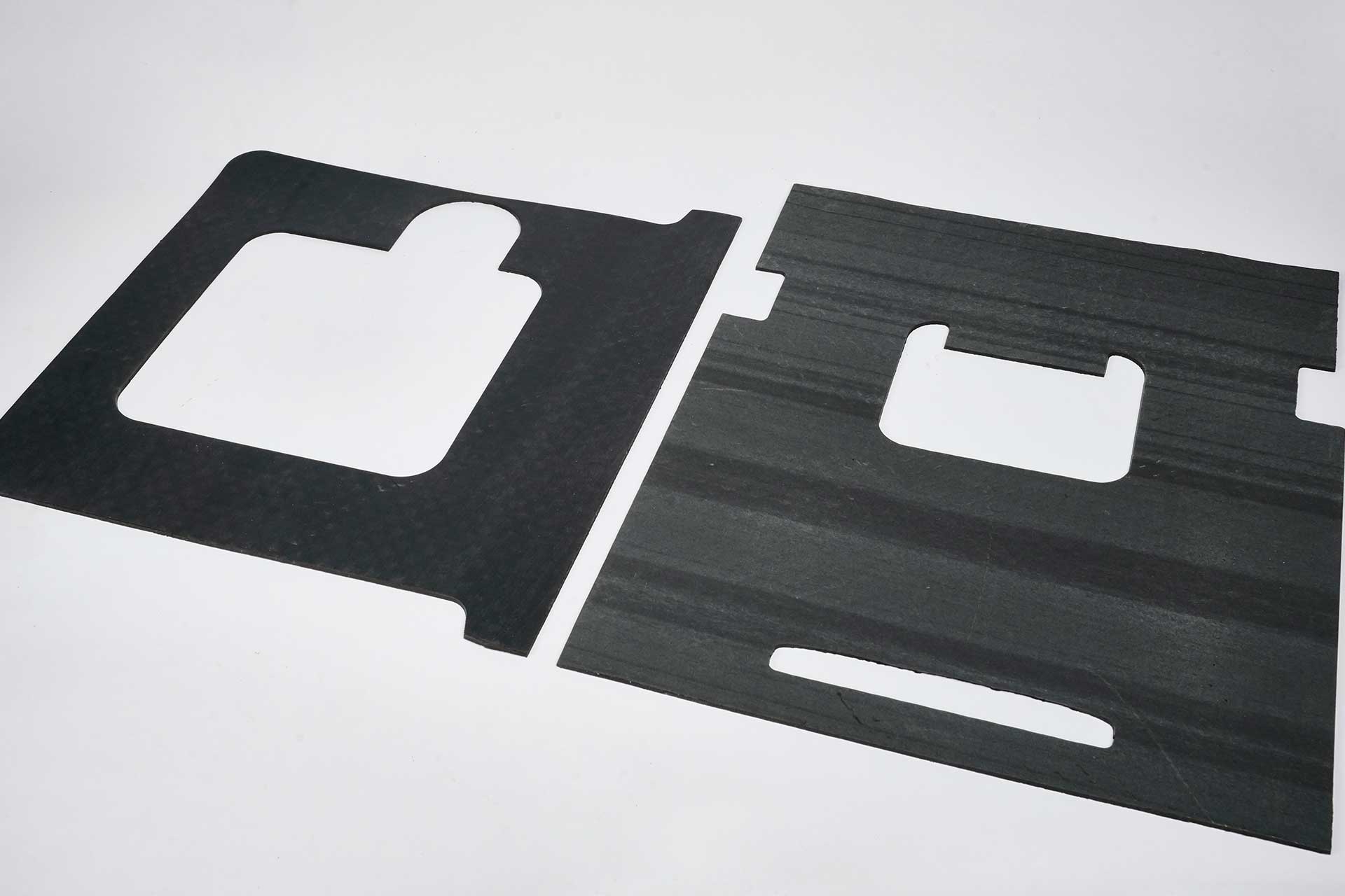 Waterjet Cutting Hero Image Two pieces of black insulation with precise cuts made with an industrial water jet cutter.