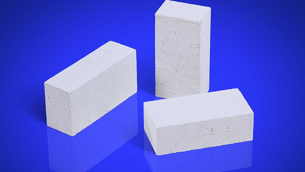 Bricks IMG 9408 Blue RGB Three large white insulating fire bricks set on a blue background.