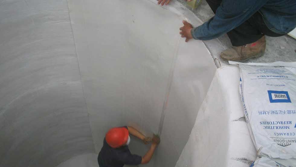 Mica Paper Installation Photo An image o the FBE crew insalling mica paper on the inside of a large refractory tunnel.