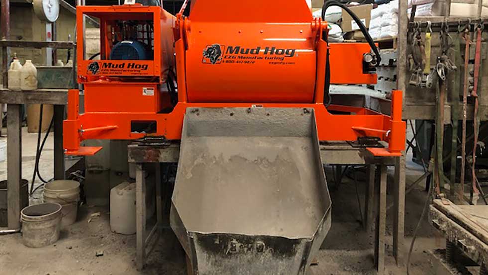 Mud Hog 1 An industrial cement mixer pours out castable refractory cement for manufacturing custom refractory shapes.
