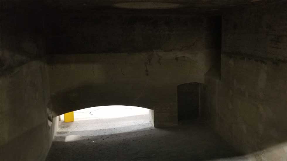 Refractory Services Furnace A dimly lit photo of a large, industrial refractory furnace.